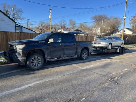 GetMyScrapCar | Chevrolet Silverado Towing a Junk Car for Scrap Metal Recycling