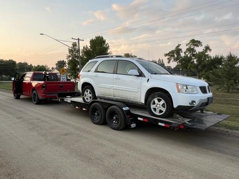 GetMyScrapCar | White Pontiac SUV Loaded on Recovery Trailer