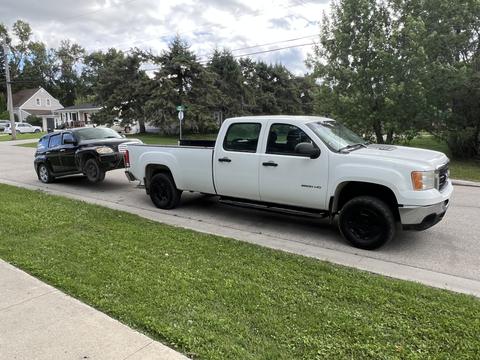 GetMyScrapCar | Junk Car Towed by Pickup for Scrap Metal Recycling