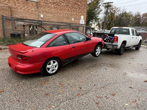 GetMyScrapCar | Junk Car Removal of a Red Chevrolet Cavalier and Pickup Truck